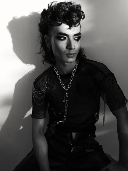 A three-quarter portrait from the punk editorial, showcasing the full hairstyle and styling. The black and white treatment emphasizes the textures and shapes.