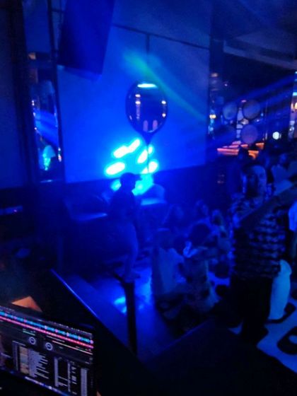 A view from my console at Maize and Malt. The blue spotlights and my visuals on the screen create a cool, immersive environment for the clubbers.