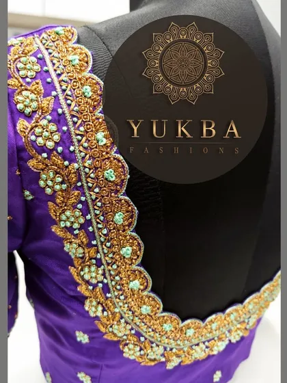 A side angle of the purple scalloped-neck blouse, giving a better view of the depth and texture of the embroidery work.