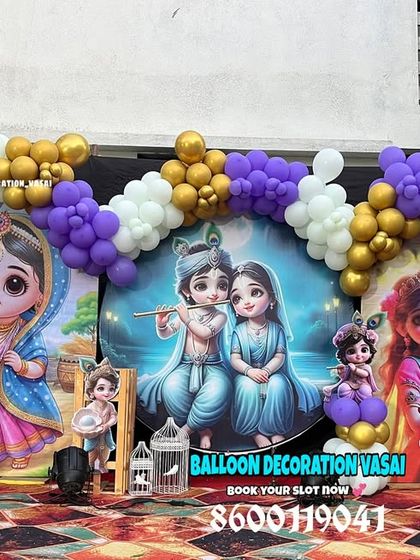 A closer view of the Krishna theme backdrop, featuring beautiful illustrations of Radha and Krishna, framed by a balloon arch.