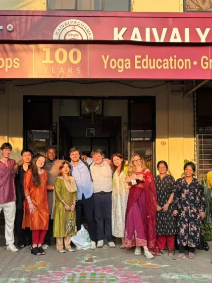 Students and instructors from Adelphi University stand outside our 100-year-old institution. This image captures the blend of our rich history and our role in global yoga education.