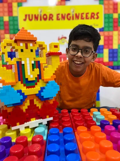 Creativity and culture come together in our special workshops. Here, a young engineer proudly displays his large, intricate Ganesha idol built entirely from LEGO bricks during our festive camp. We believe in making learning a memorable and joyful experience.