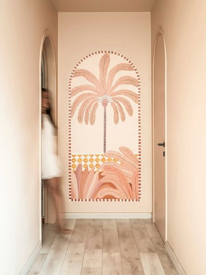 A hand-painted mural in the hallway adds a moment of artistic joy. We believe art should be a quiet companion that enhances the journey through a home.