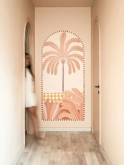 A hand-painted mural in the hallway adds a moment of artistic joy. We believe art should be a quiet companion that enhances the journey through a home.