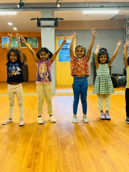 A moment of pure joy with my youngest group of dancers. These kids, aged 3 to 6, are striking a happy pose after a fun-filled session in the studio.