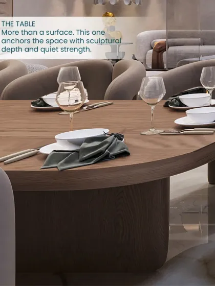 A close-up of the dining table, which anchors the space with its solid, sculptural form and warm wood finish.