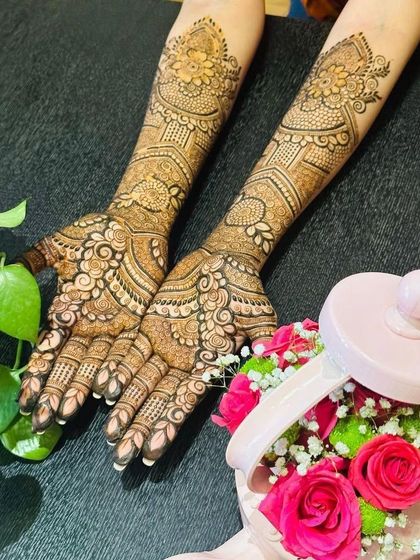 This photo highlights the symmetry and richness of the engagement mehendi. The patterns are mirrored on both hands, creating a harmonious and complete look for the bride-to-be.