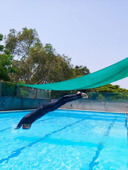 From the streamlined entry to the powerful breakout. This photo captures the transition as the dive turns into the first stroke. It's a critical moment in any race.