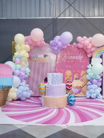 A closer look at our candy-themed birthday setup. The detailed backdrop, custom cake, and adorable props like the cupcake and ice cream cutouts make for a truly sweet celebration.