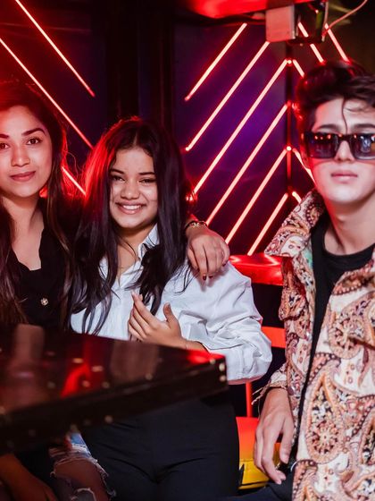 A group of friends enjoying their time at a table.