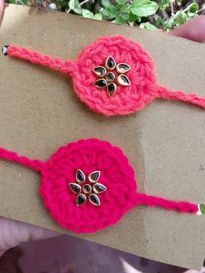 For a more traditional look, I offer these crochet kundan rakhis. The bright crochet base is adorned with a classic kundan stone centerpiece.