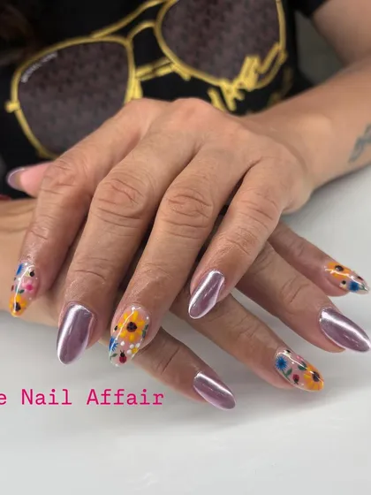 A unique combination of metallic purple chrome and hand-painted sunflowers on clear accent nails.