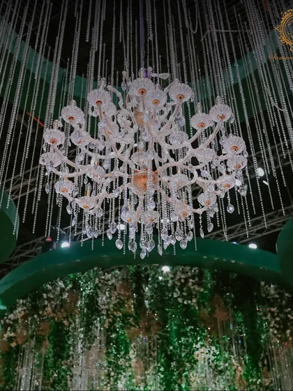 A detailed shot of one of the many crystal chandeliers, showcasing its intricate design and the way it refracts light to create a dazzling effect.