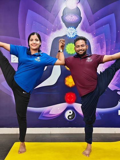 A joyful partner standing split, held with hands joined. This pose is a beautiful symbol of balance and connection.