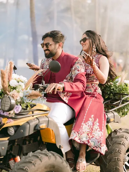 Making a grand entrance on an ATV. This shot is pure fun and adventure, perfectly showcasing the couple's playful side and the unique elements of their wedding carnival.