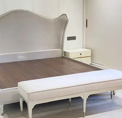 Another view of the Bedtime Beauty, showcasing the elegant silhouette of the carved wood frame and the plush, fully upholstered headboard. The matching bench at the foot of the bed completes the regal suite.