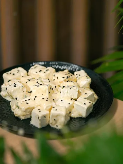 A creamy paneer dish, where soft cubes of paneer are coated in a rich, white gravy and topped with black sesame seeds. A mild yet flavorful option for guests.