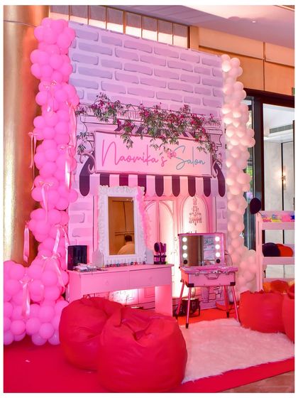 I set up 'Naomika's Salon' as a fun activity station for the Parisian party, complete with a vanity, mirrors, and bean bags for a pampering experience.