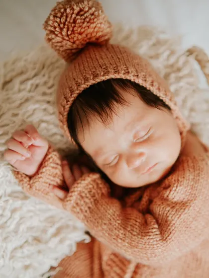 A close-up of her delicate features. Newborn photography is all about capturing these tiny, perfect details.