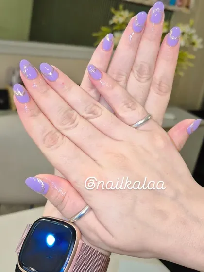 A beautiful pastel lavender manicure with delicate silver line art and a single rhinestone accent. This design is soft, feminine, and elegant.