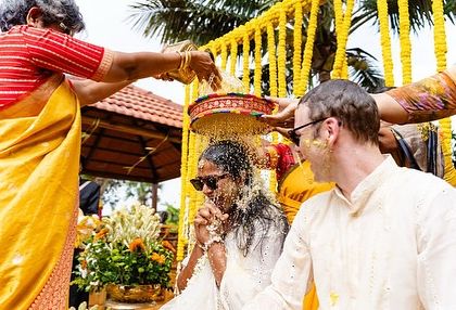 Incorporating family rituals is key to a meaningful haldi. Here, the couple is showered with flower petals and blessings, a beautiful tradition that brings everyone together.