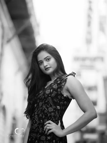 A strong and confident black and white portrait. Her direct gaze and the clean composition make this a powerful and engaging image.