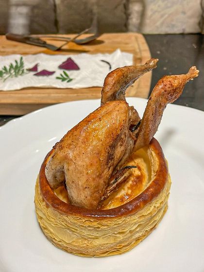 The roasted quail resting in its puff pastry "coffin" before being carved and served. A show-stopping presentation.