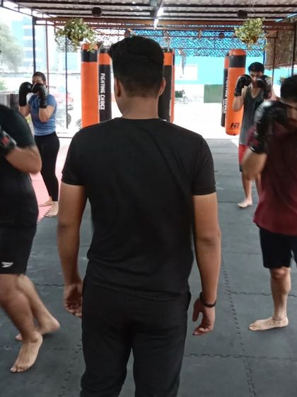 A coach observes and guides members during a boxing drill at our Sector 141 club. The layout of our facilities ensures everyone gets the attention they need.