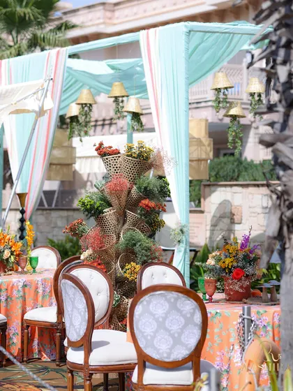 A view of the dining area, showing the tiered floral basket centerpiece and the elegant, classic chairs.