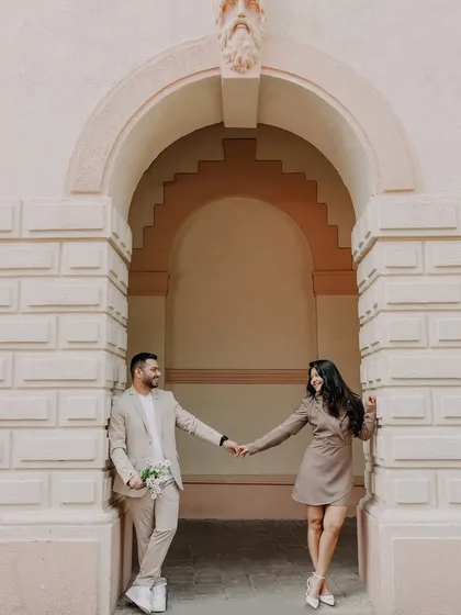 A sweet, candid moment during a pre-wedding shoot in Mumbai. Holding hands under a classic archway, this image feels both timeless and effortlessly natural.