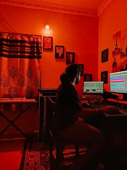 The studio environment is crucial for creativity. The orange lighting helps me get into a focused zone for producing warm, energetic house music.