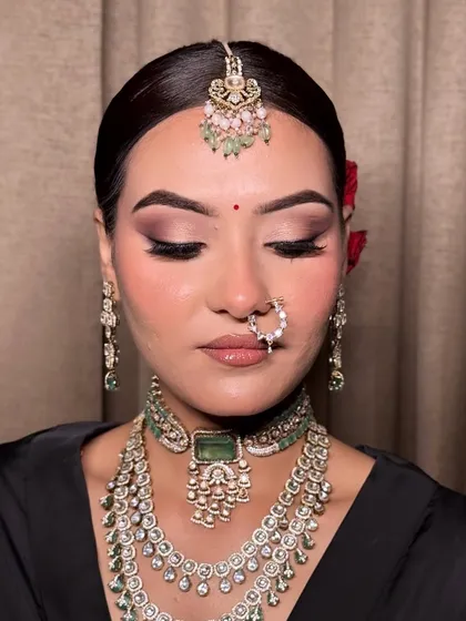A perfect example of a modern bridal look. The defined eyes, contoured cheeks, and neutral lips create a sophisticated and timeless appeal.