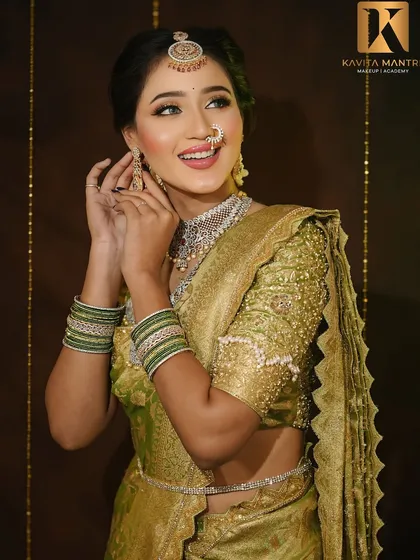 A candid shot of the bride adjusting her earring, showing the makeup from a different angle and highlighting the hairstyle with fresh flowers.