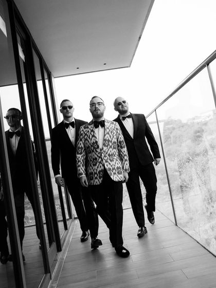 The groom and his squad, captured in a powerful walking shot. The black and white processing and strong lines of the architecture give this image a cinematic quality.