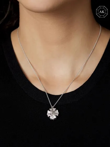 The same convertible pendant worn as a single, compact round piece. A true masterpiece of craftsmanship and innovation.