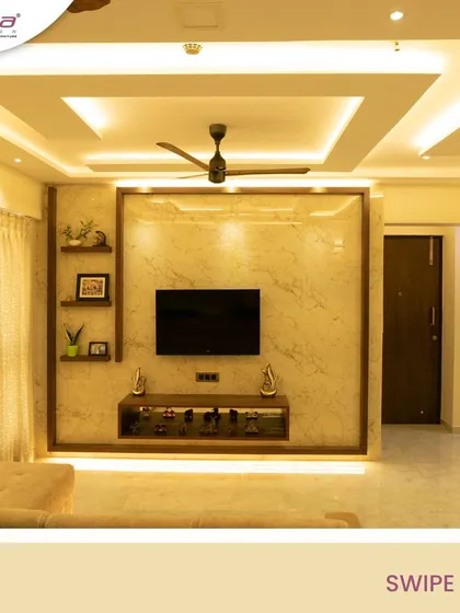 This TV unit is framed with wood and features a light marble-finish back panel. We added floating shelves for decor and integrated LED lighting under the console and around the frame to create a warm, ambient glow.