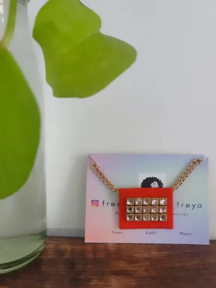 A simple and elegant fabric necklace with a square Kundan pendant. This piece is perfect for both western and traditional outfits, adding a touch of sparkle to your look.