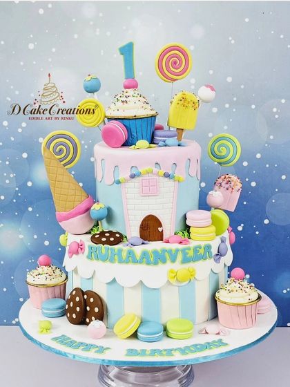 A whimsical two-tier Candyland cake for Ruhaanveer's first birthday. It's a sweet explosion of macarons, lollipops, ice cream cones, and cupcakes.