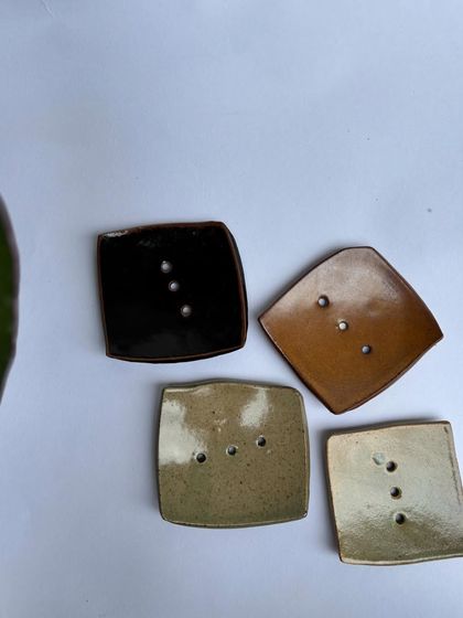 A collection of our square soap dishes in various glazes. Each one has drainage holes to keep your soap dry and lasting longer.