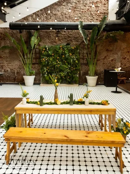 A rustic-chic setup at Cafe Panama, where we used wooden benches and a backdrop of lush greenery. The theme blended natural, earthy elements with the industrial character of the venue.