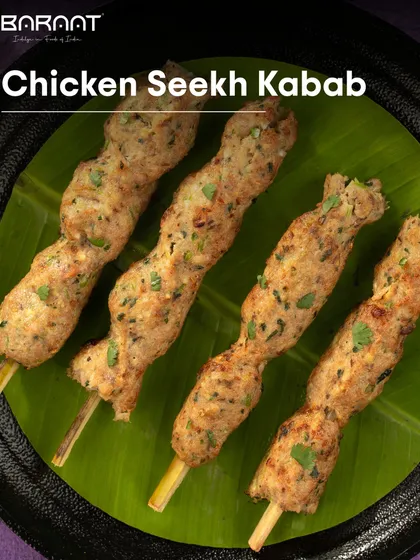 A plate of my Chicken Seekh Kebabs, perfectly grilled and served on a banana leaf for an authentic presentation.