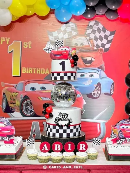 The full view of the impressive Cars-themed dessert table, complete with balloons and a custom backdrop.