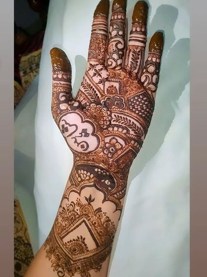 A full coverage bridal design that incorporates modern heart and cloud symbols. This is a great example of how we can weave your personal story into a traditional henna pattern.