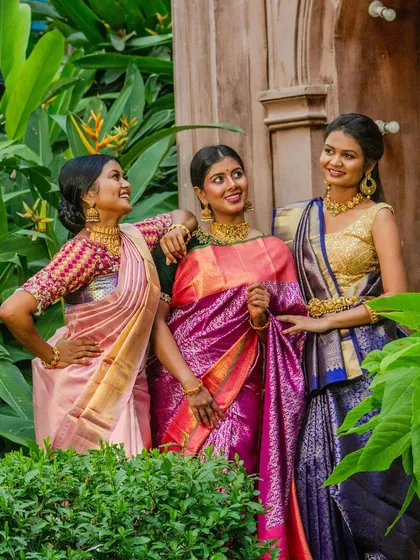 Three models showcasing a variety of our choker necklaces with different styles of silk sarees.