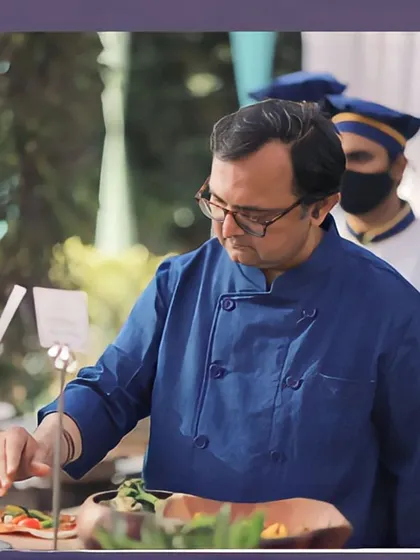 Our chef inspecting and arranging a salad at the buffet station, ensuring every dish meets our high standards of quality and presentation.