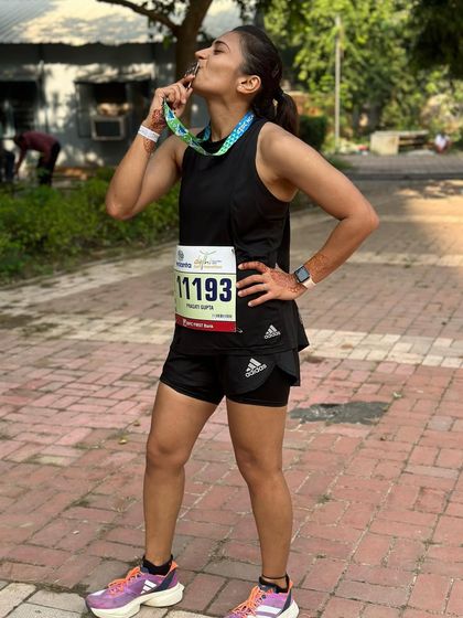 Kissing the medal after a hard-fought race at the Vedanta Delhi Half Marathon. Every medal tells a story of effort, perseverance, and the joy of running.