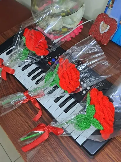 My crochet roses displayed on a keyboard, showing their versatility as decor in any space. They add a pop of color and handmade charm wherever they are placed.