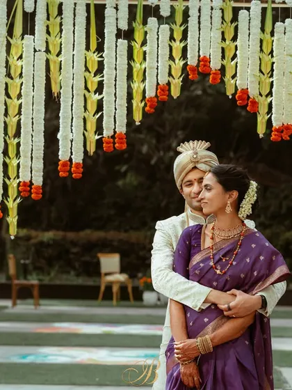 A classic portrait of a couple framed by a traditional floral arch. I work to ensure every element, from the grand structures to the delicate garlands, comes together to create timeless images you'll cherish forever.