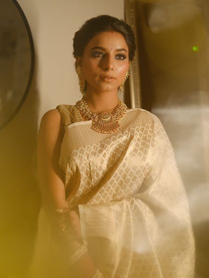 The soft, diffused lighting in this shot highlights the glowing skin and the depth of the smokey eye makeup.