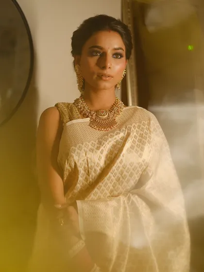 The soft, diffused lighting in this shot highlights the glowing skin and the depth of the smokey eye makeup.